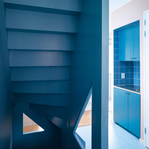 The two founders of Lagado Architects have revamped their own townhouse in Rotterdam to feature bold live-work spaces and a sculptural blue staircase.
